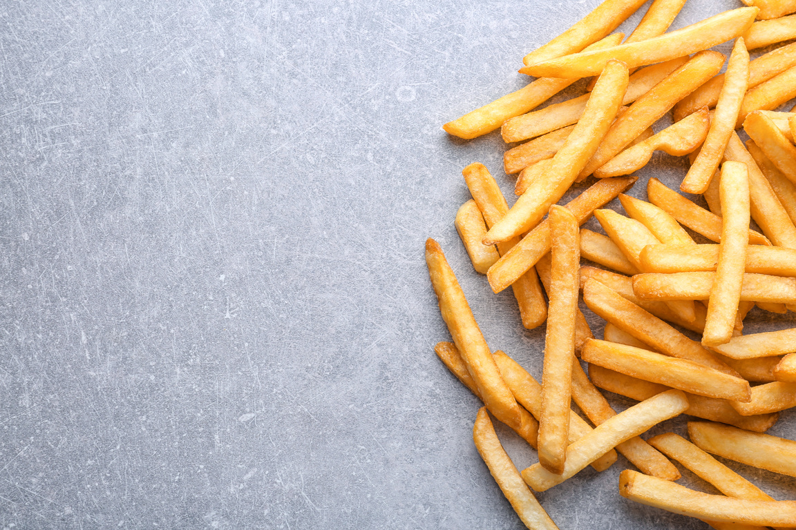 Yummy French Fries on Grey Background
